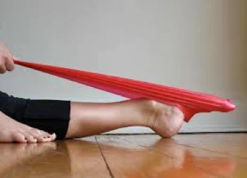 Seated with leg straight, pushing the foot down into a resistance band held in the hands to point the toes