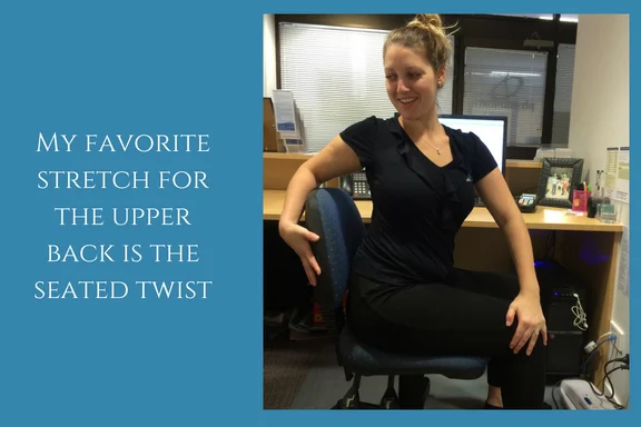 Woman seated on an office chair with legs crossed, twisting her upper body to one side for an upper back stretch