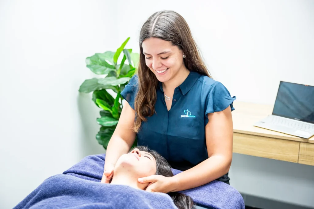 A massage therapist gently massaging a patient’s neck and shoulders